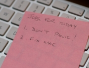keyboard with note on it saying don't panic